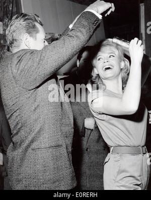 Actress Brigitte Bardot joking with actor Danny Kaye at a film studio in Paris Stock Photo