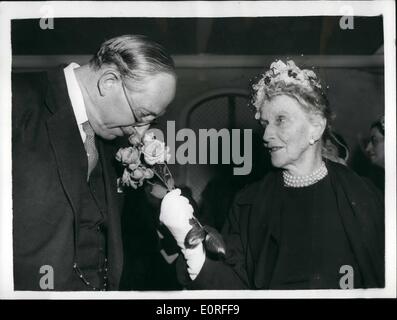 May 05, 1959 - Floral Luncheon at the Savoy hotel: A luncheon and floral arrangement competition to raise funds for the Forces Help Society and Lord Roberts Workshops was held at the Savoy Hotel today. Photo shows Lord Salisbury bends to smell a spray of roses held by Nancy Lady Astor at Today's luncheon. Lady Astor celebrated her 80th birthday last Wednesday. Stock Photo