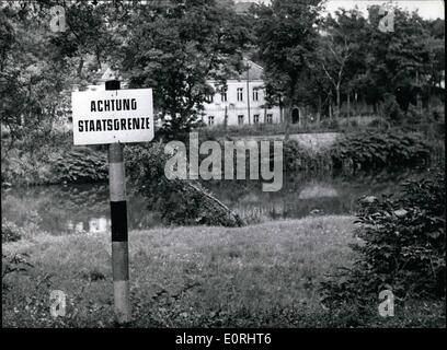 Sep. 09, 1959 - Oder-Neisse-Border is ''Stateborder'': 20 years ago, on the 1st Sept. 1939, Poland was invaded by Hitler's SS. When the Russians set Poland free there was drawn a provisional border in 1945 between Germany and Poland; the ''German Democratic Republic'' and Poland made a ''stateborder'' of that. Photo shows was taken in Aug. 1959 at the Neisse near Gorlitz (GORLITZ). The sign in front is on german ground; the house on the other side of the river Neisse belongs already to Poland. Stock Photo