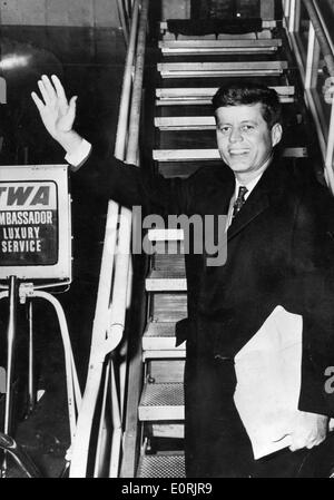 President John F. Kennedy waves while boarding plane Stock Photo