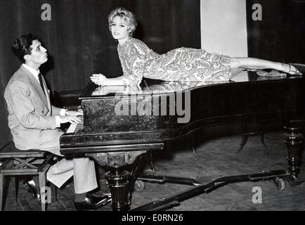 Singer Gilbert Becaud singing to actress Brigitte Bardot Stock Photo
