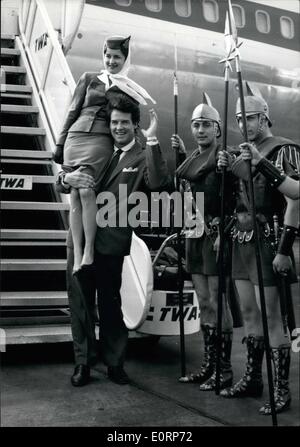 Apr. 04, 1960 - Steve Reeves In Paris: Steve Reeves, The Famous American Actor Athlete Is Now In Paris For The Premiere Of His Film ''The Last Days Of Pompei''. Photo shows Steve Reeves Lifts In His Strong Arms An Air Hostess While Friends Dressed Like Roman Legionnaires Greet Him On His Arrival At Orly Airfield. Stock Photo