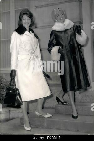 May 05, 1960 - Mac Douglas shows his Autumn-Winter Collection: Mac Douglas, the well-known Paris tailor specialised in leather wear, is now showing his autumn and winter collection. Photo Shows left, a coat in smooth white lamb with belt and mink collar. This coat is entitled ''Farandole''. On right ''Flamenco'' a coat in black glazed lamb, with white collar and trimmings. Stock Photo