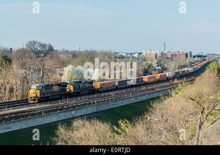 Long freight train pulls along track from Washington DC to Alexandria in Virginia, USA Stock Photo