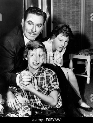 Actor Errol Flynn and boys in film scene Stock Photo