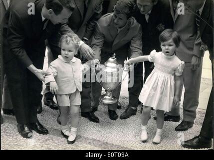 May 18, 1960 - What kind of toy is it?: Little Prince Albert and his sister Princess Caroline, children of Prince Rainier and Princess Grace of Monaco, look somewhat bewildered as footballers of the Monaco team put into their hands the cup final trophy they won in Paris last Sunday. Stock Photo