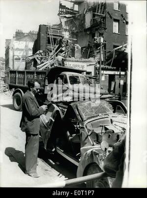 Jul. 06, 1960 - Shop Collapses And Wrecks Pre-War Car... Mr. Hugh Walters of Norbury a school-teacher left his 1938 Ford '8' car in Lisle St., Soho, yesterday - while he went to keep an appointment at a Soho hospital.. While he was away building alongside that was under process of demolition - collapsed of its own volition fifty tons of debris crashed down on the car - turning it into a complete wreck.. Luckily no one was hurt. Photo Shows: Mr Hugh Walters looks at the wreckage of his car - after the crash of the building - yesterday. Stock Photo