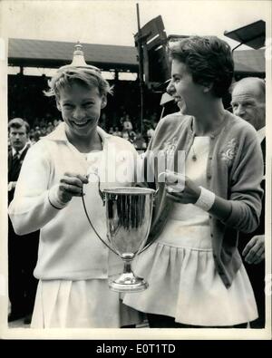 Jul. 07, 1960 - Women's Doubles Final at Wimbledon: Fun with the Cup. Photo shows Darlene Hard (USA) has a spot of fun by placing the lid of the Ladies' Doubles Trophy - which she and Maria Bueno (Brazil) won by beating the South African Pair - Miss Reynolds and Miss Schuurman - at Wimbledon this afternoon. Stock Photo