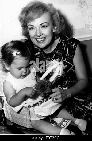 Jul 08, 1960 - New York, New York, U.S. - Actress and singer EDIE ADAMS, the blonde beauty who won a Tony Award for bringing Daisy Mae to life on Broadway and who played the television foil to her husband, comedian Ernie Kovacs, has died. She was 81. Edie Adams, seen here in 1963, became most famous for her role in a cigar commercial. Adams died Wednesday in a Los Angeles hospital from pneumonia and cancer Caption: Lovely actress Edie Adams playfully amuses her one year old daughter MIA KOVAC prior to winging their way via TWA's Superjet to their home in Los Angeles. Stock Photo