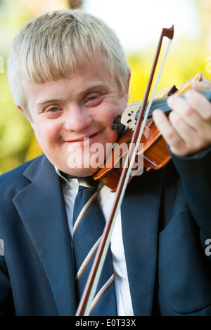 Close up portrait of young handicapped violinist outdoors. Stock Photo