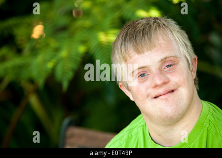 Close up face shot of friendly handicapped boy outdoors. Stock Photo