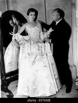 Fashion designer Christian Dior fitting a woman's gown Stock Photo