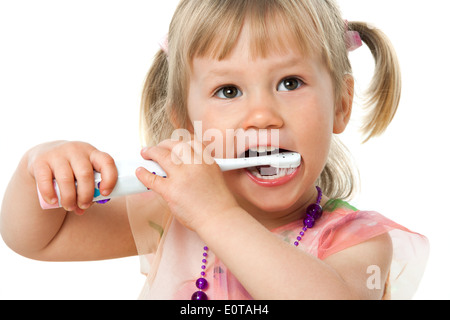 Close up portrait of little girl brushing teeth.Isolated on white background. Stock Photo