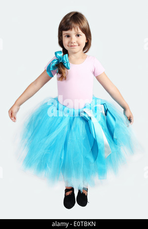 Little Girl Performing in Tutu Skirt Studio Shot over Grey Stock Photo