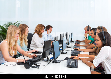 Group of young students doing training course on computers. Stock Photo