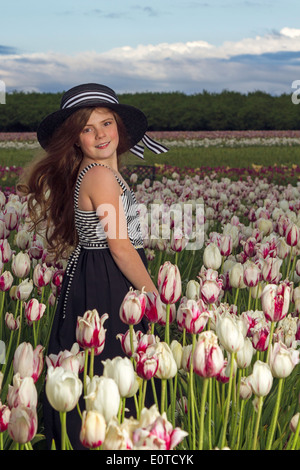 Young girl enjoying a tulip field Stock Photo