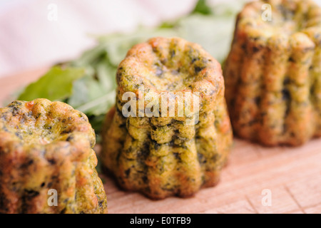 Spinach and salmon canneles, a variation of the traditional cannele recipe from Bordeaux, France Stock Photo