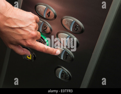 Hand is pressing the 1th floor Stock Photo