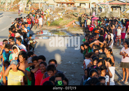 Tacloban City people waiting on the long food aid queue Philippines. Stock Photo