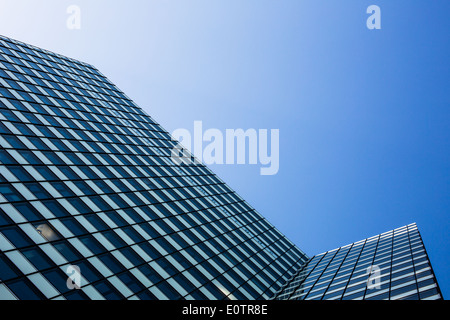 Exterior of building - abstract concept; skyscraper from down below against blue sky Stock Photo