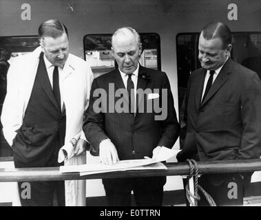 Henry Ford II looking over plans with two colleagues Stock Photo