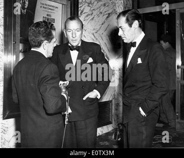 Rex Harrison and Noel Coward are interviewed at party Stock Photo