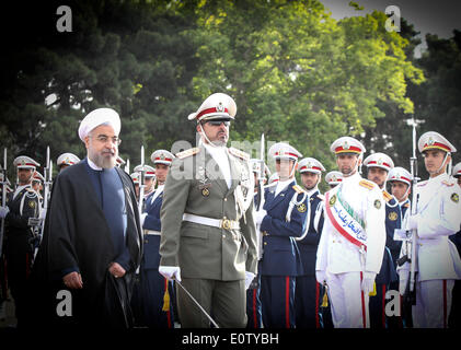 (140520)-- TEHRAN, May 20, 2014 (Xinhua) -- Iranian President Hassan Rouhani (L) inspects the honour guards before leaving for China at Mehrabad Airport in Tehran, Iran, on May 20, 2014. Rouhani left Tehran for Shanghai on Tuesday morning to attend the Conference on Interaction and Confidence Building Measures in Asia (CICA) summit, to be held in Shanghai on May 20-21. (Xinhua/Ahmad Halabisaz) (zjy) Stock Photo