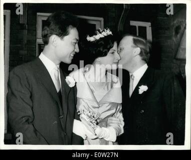 Dec. 12, 1960 - Yehudi Menuhin's Daughter Weds Chinese Pianist- The wedding took place at Hampstead Register Office this morning of twenty year old Zamira Menuhin daughter of world famous violinist Yehudi Menuhin - and twenty six year old Mr. Fou Ts-ong who fled from Communist China to the West - two years ago to earn fame as a pianist. Keystone Photo Shows:- Yehudi Menuhin gets a kiss from his daughter - after the wedding at the Register Office this morning. JSS/KEYSTONE EM/726123 Stock Photo