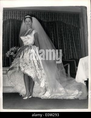 Dec. 13, 1960 - Jackie Collins Weds At Grosvenor House. Bride In Her 400. Photo shows The bride showing her white satin wedding Stock Photo