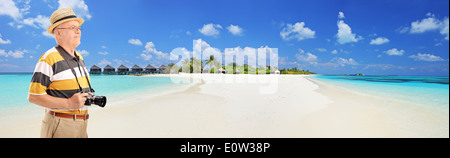 Panoramic view of a male tourist standing on a tropical beach at Maldives islands Stock Photo