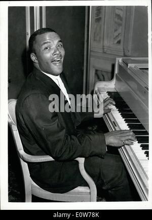 Oct. 10, 1961 - Luncheon to meet Eddie Machin - Brian London's New Opponent: American boxer Eddie Machin attended a luncheon reception at the Trocadero, Piccadilly - this afternoon. He is in London for his contest with Britain's Brian London at the Empire Pool, Wembley on Tuesday October 17th. Photo shows Eddie Machin 'limbers up' with a song at the piano at the Trocadero this afternoon. Stock Photo