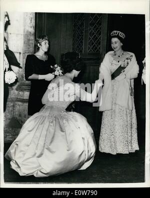 Oct. 10, 1961 - Bouquet for the Queen: Lady Mayoress Lady Waley-Cohen's beautiful gown billows as she presents a bouquet of flowers to the Queen at a reception at the Magistrates' Association in Guildhall, City, last night. The reception was held to commemorate the 600th anniversary of the Statue of Edward III, which constituted Justices of the Peace. Stock Photo