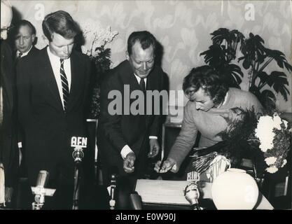 Feb. 02, 1962 - Robert F. Kennedy in West Berlin: Photo shows Mrs. Ethel Kennedy, the wife of the Attorney General signed the Golden Book of Berlin,. Left from her the Governing Mayor Willy Brandt, extreme left the Attorney General Robert F. Kennedy. Stock Photo