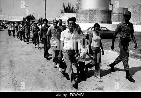 Official leads newly arrived Cuban refugees to camp Stock Photo