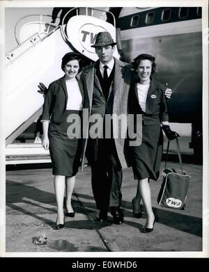 Jan. 01, 1963 - Greeted upon his arrival via TWA Jet liner from Paris, is popular French actor Yves Montand with lovely hostesses Janice Abbott on left, and Jackie Roberts. Mr. Montand is en route to Washington, D.C. to entertain at the Second Innaugural Salute for President John F. Kennedy, which takes place January 18th. Stock Photo