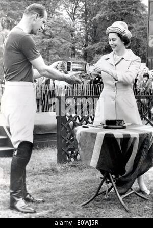 Queen Elizabeth II handing over the 'Royal Windsor Horse Show Cup' to her husband Prince Philip Stock Photo