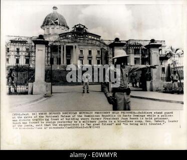 Sep. 26, 1963 - Where Deposed Dominican Republic President Held Prisoner : Soldiers stand guard at the gates of the National Palace of the Dominican Republic in Santo Domingo while a police man directs traffic in front of building where former President Juan Bosch is held prisoner. Bosch was forced to resign yesterday by a military junta in a bloodless coup. Gen. Imbert, leader of the Junta, said that the ex-president is ''my good friend'' and ''is being well treated. Stock Photo