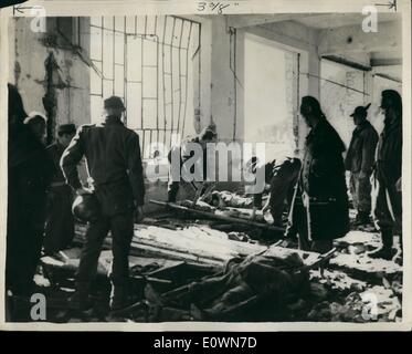 Oct. 10, 1963 - Scene of the Italian dam disaster. Attending the bodies at Longarone: It is feared that four thousand people lost their lives when part of the 6,000 ft. Mount toc crashed down into the huge Vaiont dam Nr. Venive sending millions of tons of water crashing through the town of Longarone and surrounding villages. Photo Shows Firemen and other rescue workers attending to some of the many bodies in the ruins of a building after the disaster at Longarone. Stock Photo