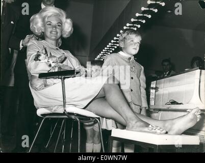Oct. 10, 1963 - Jayne Mansfield the explosive American actress arrived yesterday to Rome to star in the film ''The Mansfield world'' was pictured today at the Hotel Hilton hairdresser while she was under the cure of two hairdresser while she was under the cure of two hairdresser who tried on her a new sensational hairdressing called ''Trambling'' the actress is expecting a baby. Stock Photo