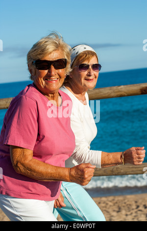 Portrait of friendly senior ladies in casual sportswear outdoors. Stock Photo