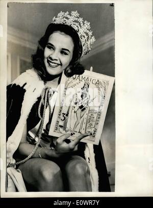 Nov. 22, 1963 - 22-11-63 Miss Jamaica appears on stamps. Carole Joan Crawford, Miss Jamaica, who won the Miss World title in London recently, is being used as a model for a stamp design by the Jamaican Government. This is the first known case of a beauty queen in a swim suit appearing on a postage stamp. The stamps, 4,000,000 of them, are being printed in London. Photo Shows: Miss Jamaica in London yesterday with the design of the stamp. Stock Photo