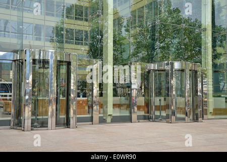 entrance to modern office block via glass revolving doors Stock Photo