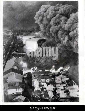 Jun. 22, 1964 - Japanese Earthquake Disaster: The city of Niigata was reduced to a blazing shambles by the earthquake which struck last Tuesday, isolating it from the rest of Japan, as railway lines buckled and the runway of the airport partly disappeared. Now there is no water, electricity, of sewerage, and thousands are homeless. The port of Niigata, one of the principal oil refining cities, suffered a double catastrophy as oil tanks burst spreading blazing oil over hundred of houses nearby, destroying 291 of them. The 90 oil tanks which went up in flames contained 400,000 kiloliters Stock Photo