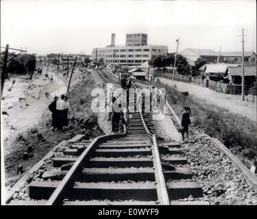 Jun. 22, 1964 - Japanese Earthquake Disaster. The city of NIIGATA was reduced to a blazing shambles by the earthquake which struck last Tuesday, isolating it from the rest of Japan, as railway lines buckled and the runway of the airport partly disappeared . Now there is no water, electrician of sewerage, and thousands are homeless. The port of Niigara, one of the principal oil refining cities, suffered a double oatastrophy as oil tanks burst spreading blazing oil over hundreds of houses nearby, destroying 291 of them. The 90 oil tanks which went up in flames contained 400,000 kilolitres Stock Photo