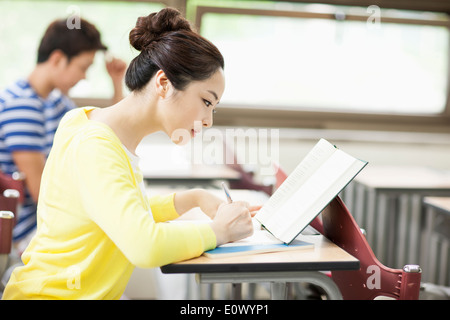 a woman studying in class