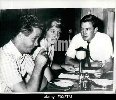 Mar. 03, 1965 - Dawn Fraser and Husband Consult Solicitor on Possible Legal Action Against Swimming Ban: Australia's most famous swimmer Dawn Fraser accompained by her husband Gary Ware had a consultation with their solicitor in Sydney in connection with possible legal action following the banning of Dawn from competing in International Swimming events for the next ten years. The ban was imposed by the Australian Swimming Union in connection with alleged ''Incidents'' during the Tokyo Olympic Games. Photo shows Dawn Fraser and husband Gary Ware (left) and solicitor Mr.E Stock Photo