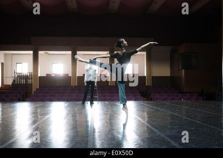 (140520) -- BEIJING, May 20, 2014 (Xinhua) -- Xu Yan, a 19-year-old ballerina of the National Ballet of China, practices in an empty auditorium in Beijing, capital of China, March 12, 2014. Before being able to present perfect performance in the spotlight, every member of the National Ballet of China has to undergo severe arduous training for years. Yet they chose to persevere in what they truely love. Years of toiling not only allows them good body shape, expertise and disposition, but also offers them a life-long goal that deserves pursuing. The glory on stage is only a small fraction of all Stock Photo