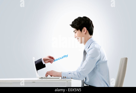 a hand coming out from a business mans laptop Stock Photo