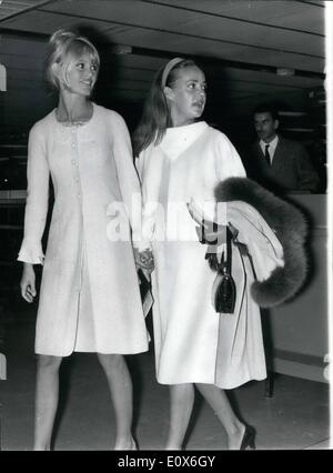 May 05, 1965 - OPS: Jeanne Moreau and Brigitte Bardot both wearing white dresses pictured at Orly Airport . They are seen walking hand in hand no doubt as a demonstration of their good friendship in spite of ''All The Gossip' Stock Photo