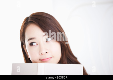 a woman holding a white book Stock Photo